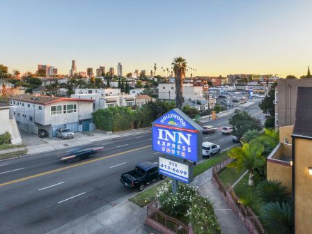 A cityscape with a road, cars, and buildings, featuring an 